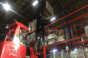 Flexi truck loading pallet onto racking