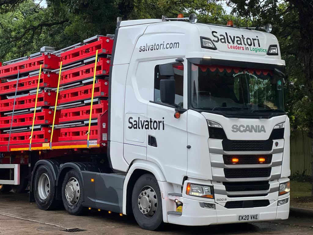 Salvatori truck witl flatbed trailer, loaded with construction material leaving from port of Tilbury