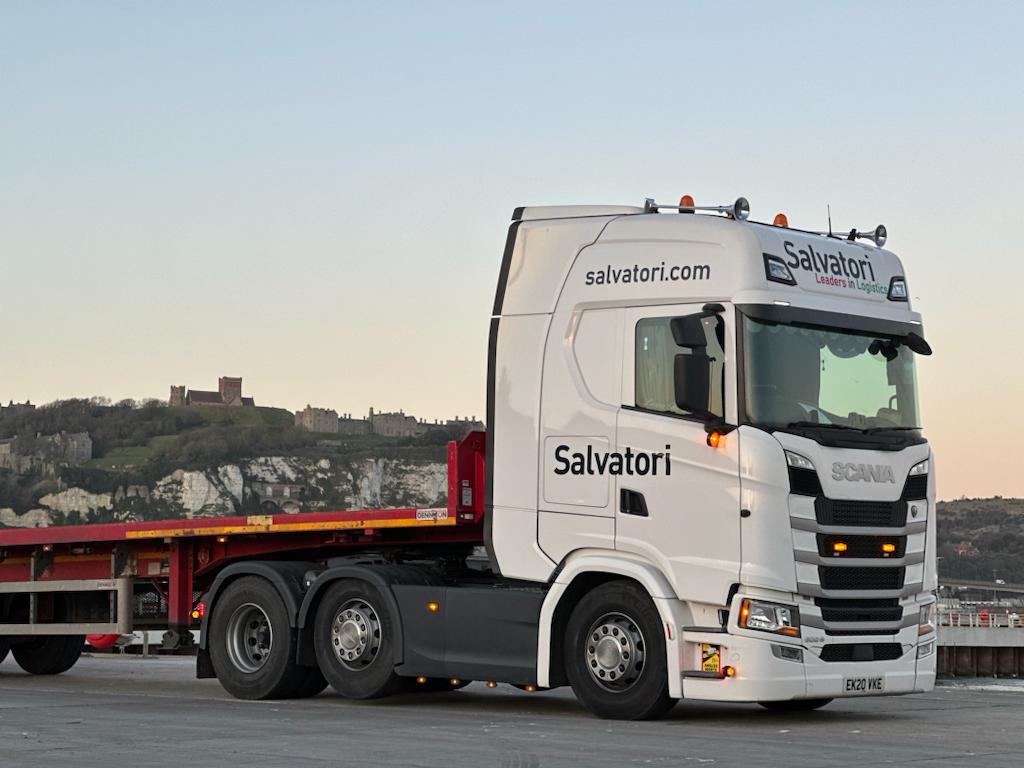 Salvatori truck and flatbed trailer waiting to load building materials.